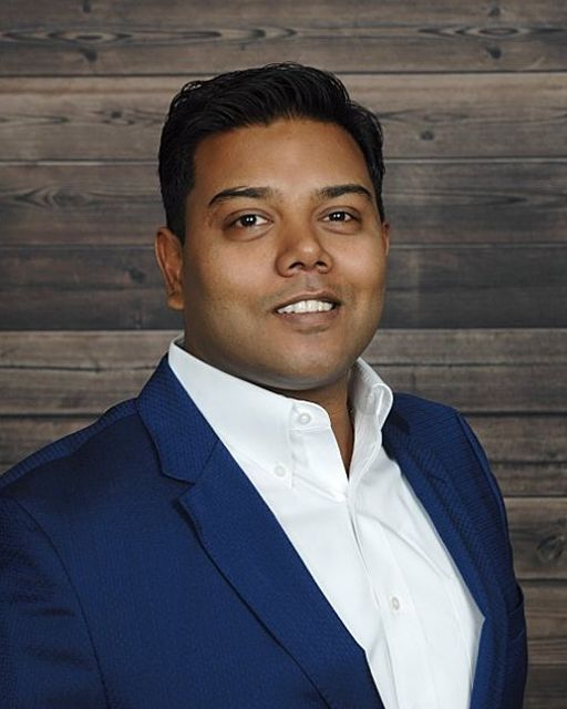 A man in a blue suit and white shirt