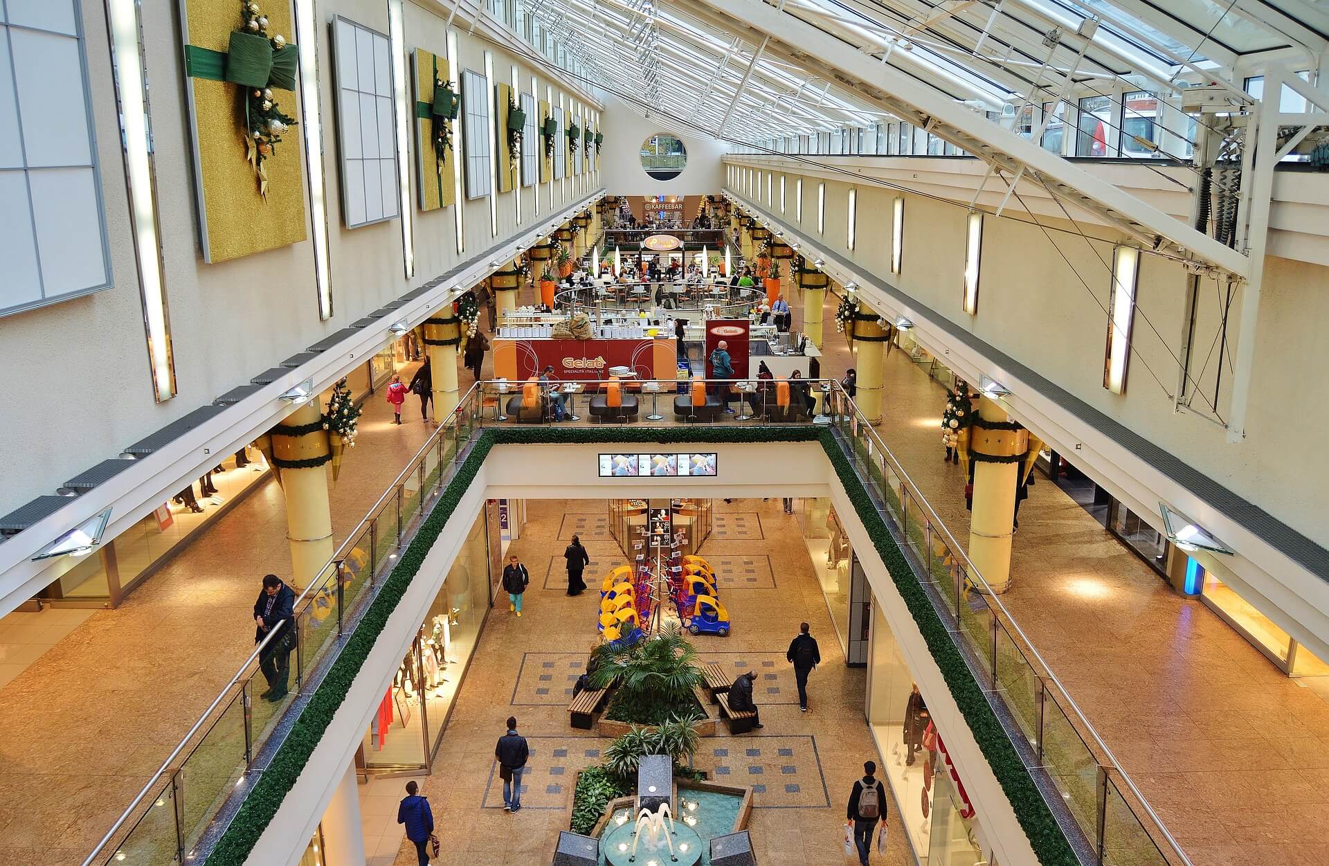 A large shopping mall with people walking around.